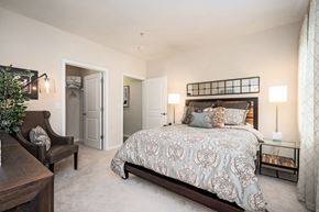 Chesapeake apartment for rent - A bedroom with a large bed and a chair.