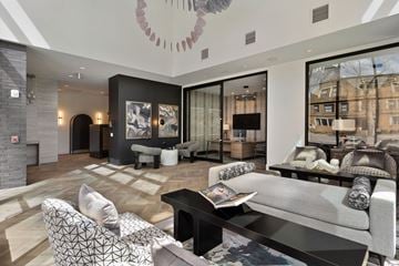 Columbus apartment for rent - A modern living room with a grey sofa and a black coffee table.