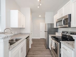 Raleigh apartment for rent - a kitchen with granite counter tops and stainless steel appliances