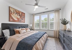 Clover apartment for rent - A bedroom with a large bed and a ceiling fan.