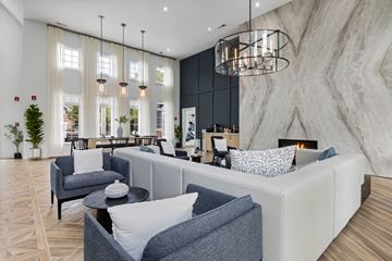 Raleigh apartment for rent - A modern living room with a grey sofa and a black coffee table.