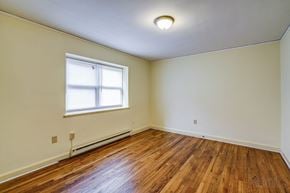 Raleigh apartment for rent - A room with a window and wooden flooring.