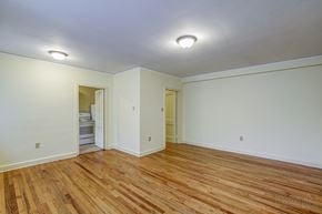 Raleigh apartment for rent - A room with wooden floors and white walls.