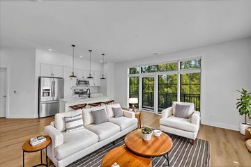 Newport News apartment for rent - A modern living room with a white couch and a coffee table.