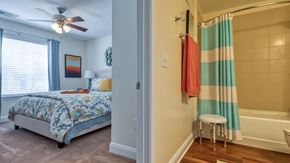 Blacksburg apartment for rent - A bedroom with a bed and a bathroom with a shower.