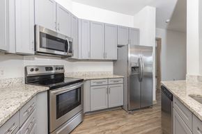 Morrisville apartment for rent - a kitchen with white cabinets and stainless steel appliances