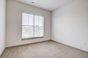 Morrisville apartment for rent - a bedroom with a large window and a carpeted floor