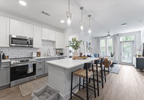 Clover apartment for rent - A modern kitchen with a large island and bar stools.