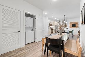 Delray Beach apartment for rent - a dining area with a table and chairs and a kitchen with a washer and dryer