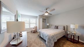 Raleigh apartment for rent - a bedroom with a bed and a ceiling fan