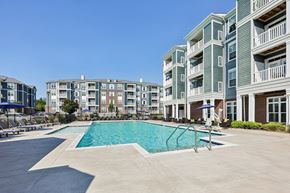 Fredericksburg apartment for rent - A swimming pool is surrounded by apartment buildings.