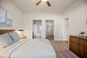 Clayton apartment for rent - A bedroom with a large bed and a ceiling fan.