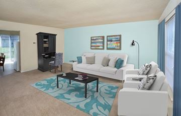 Richmond apartment for rent - A living room with a white couch and a black coffee table.