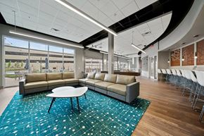 Glen Allen apartment for rent - a lounge area with couches and a tableat Metropolis Apartments, Glen Allen, VA 23060