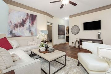 Charlotte apartment for rent - A living room with a white couch and a painting on the wall.