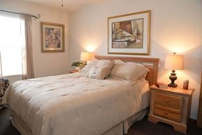 Marysville apartment for rent - A bedroom with a large bed and two lamps.