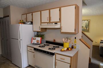 Marysville apartment for rent - A kitchen with a white refrigerator and a stove top oven.