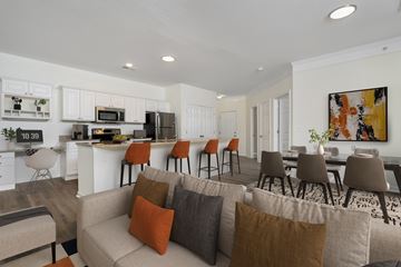 Hilliard apartment for rent - A modern living room with a grey couch and a painting on the wall.