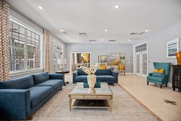 Apex townhouse for rent - A living room with a blue couch and a coffee table.