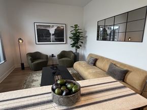 Newport News apartment for rent - A living room with a couch, chair, and a bowl of fruit on the coffee table.