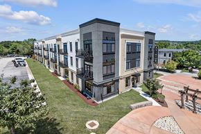 Newport News apartment for rent - A modern apartment complex with a mix of beige and dark grey buildings.