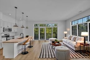 Newport News apartment for rent - A modern kitchen with white cabinets and a wooden island.