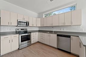 Glen Allen apartment for rent - a kitchen with white cabinets and stainless steel appliancesat Metropolis Apartments, Virginia, 23060