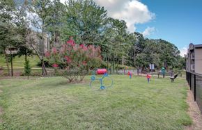 Little Rock apartment for rent - people playing in the yard of a park with a hoop and a basketball court
