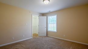 Forest apartment for rent - a room with carpet and a door and a window
