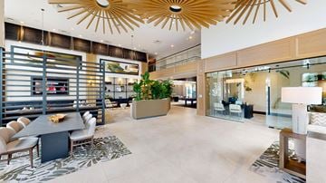 Delray Beach apartment for rent - A modern living room with a dining table and chairs.