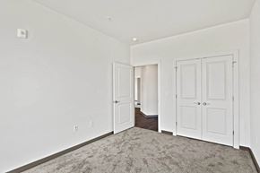 Glen Allen apartment for rent - a bedroom with white walls and doors and a carpetat Metropolis Apartments, Virginia, 23060