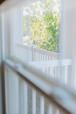 Sunbury apartment for rent - A white window frame with a view of green trees outside.