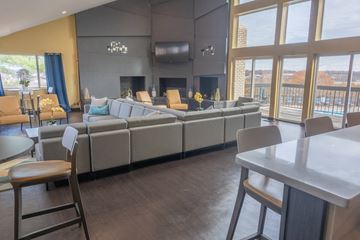 Antioch apartment for rent - A modern living room with a grey sofa and a fireplace.