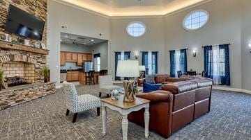 Lynchburg apartment for rent - A living room with a stone fireplace and a television above it.