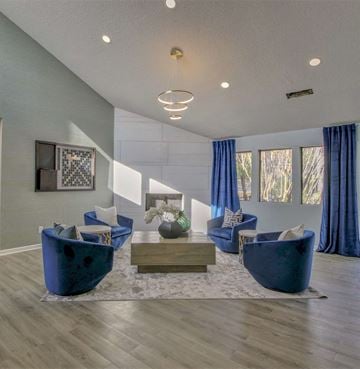 Little Rock apartment for rent - A living room with blue chairs and a coffee table.
