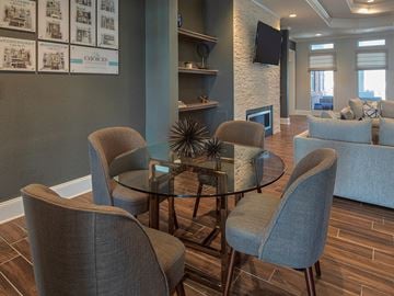 Virginia Beach apartment for rent - A living room with a glass table and grey chairs.