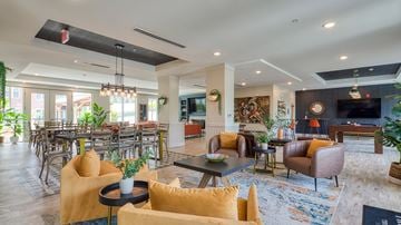 Glen Allen apartment for rent - A living room with a yellow chair and a black coffee table.