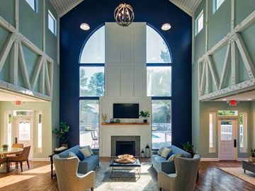 Newport News apartment for rent - A large room with a fireplace and a TV on the wall.