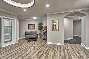 Virginia Beach apartment for rent - A living room with a grey couch and a wooden floor.