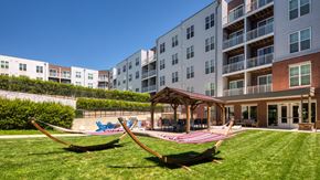 Glen Allen apartment for rent - A playground with a swing set and a building in the background.