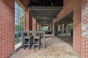 Dublin apartment for rent - A patio with a table and chairs is surrounded by red brick walls.