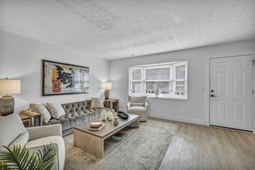 Dublin townhouse for rent - A living room with a grey couch, a coffee table, and a painting on the wall.