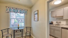 Norfolk apartment for rent - a kitchen with a small table and two chairs next to a window
