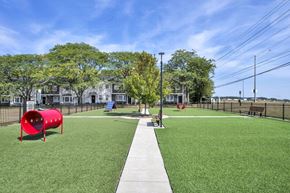 Dublin townhouse for rent - A playground with a red tunnel and a green lawn.