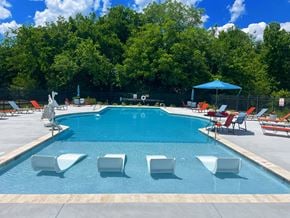 Williamsburg apartment for rent - A pool with chairs and a blue umbrella.