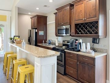 Morrisville apartment for rent - A kitchen with brown cabinets and yellow stools.