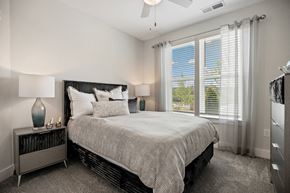 Durham apartment for rent - a bedroom with a bed and a large window at Ellis Station, North Carolina, 27703