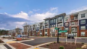 Midlothian apartment for rent - an exterior view of an apartment building on a city street at The Bella at Westchester, Virginia