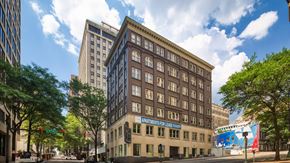 Richmond apartment for rent - A street view of a city with a building that has a sign that says "Apartments for Lease".