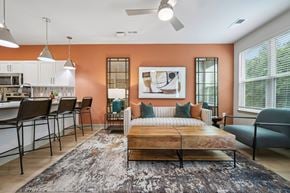 Raleigh apartment for rent - A bedroom with a bed, a couch, and a dining table.